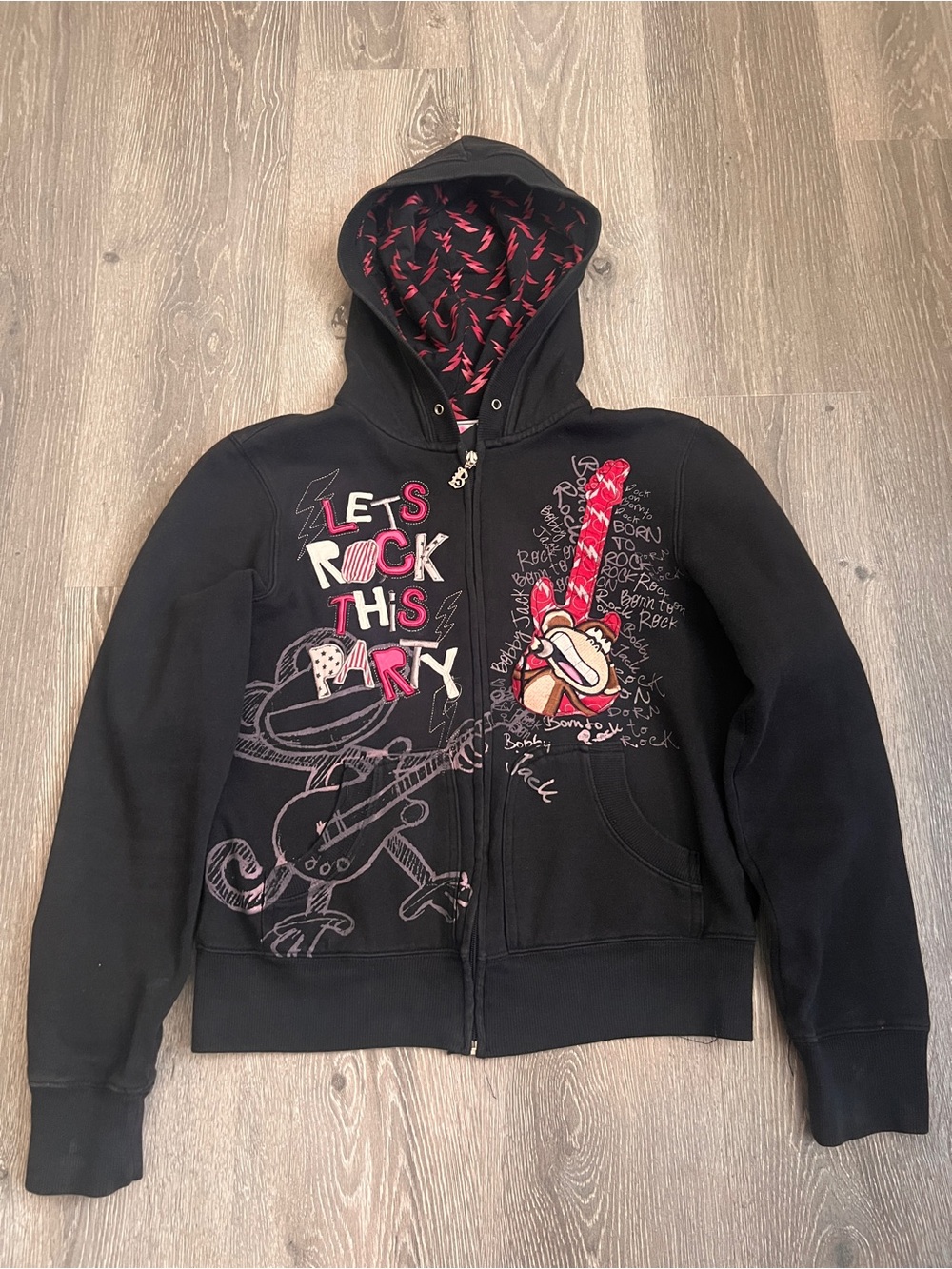 Bobby Jack black zip up hoodie with graphic of a monkey playing a guitar